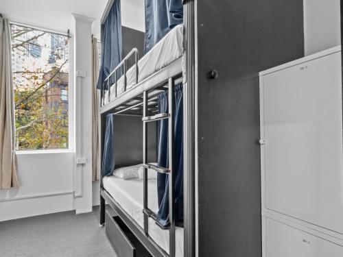 a room with two bunk beds with a window at AZZURRO POD HOTEL - Central Sydney in Sydney