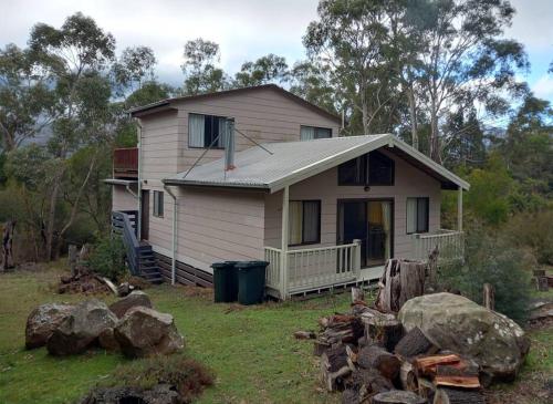 a small house in a yard with rocks at Grampians Trail Cottage in Halls Gap