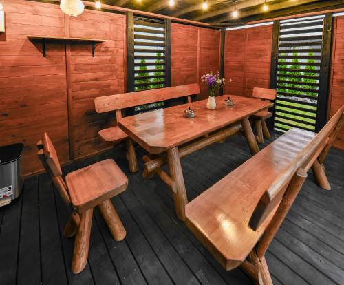 a dining room with a wooden table and chairs at Apartmány K&K in Liptovský Hrádok