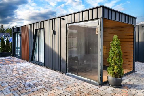 a small house with a glass door on a patio at Apartmány K&K in Liptovský Hrádok