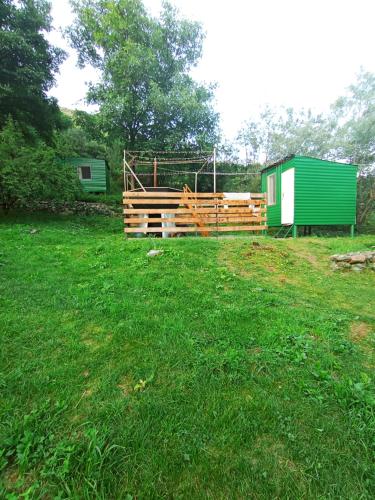 a yard with a fence and a green shed at Camping Three poplars by VL in Alaverdi