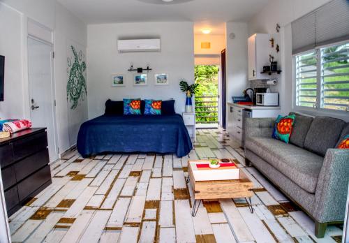 a living room with a bed and a couch at The Beach Pad Puntas in Rincon