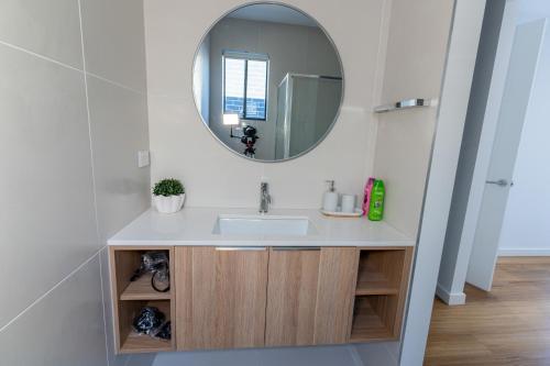 a bathroom with a sink and a mirror at Luxury home away from home in Mickleham