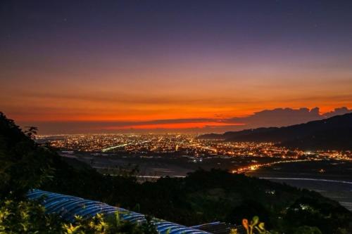 a view of a city at sunset from a mountain at Hao Wang Jiao House in Datong