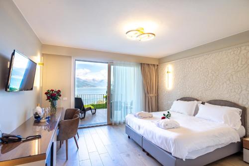 a hotel room with a bed and a desk and a window at Borgo Le Terrazze in Bellagio