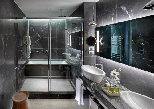 a bathroom with a shower and a sink and a tub at Mandarin Oriental, Milan in Milan