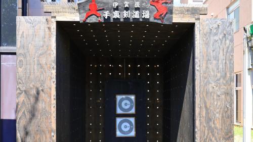 a large black entrance to a building with paintings on it at Hill Hotel Sunpia Iga in Iga