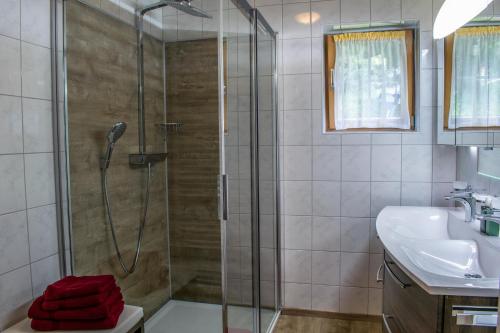 a bathroom with a shower and a sink at Weinzeit Chalet in Königsleiten