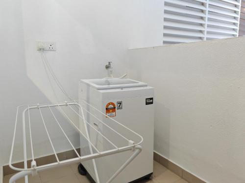 a small refrigerator in a room with a sink at Mykey Amber Cove A-23-23 Melaka City in Melaka