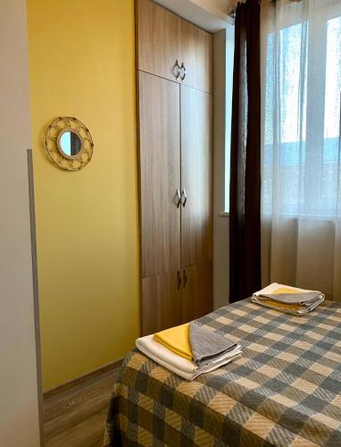 a bedroom with a bed with a dresser and a mirror at Design Studio in Gyumri in Gyumri