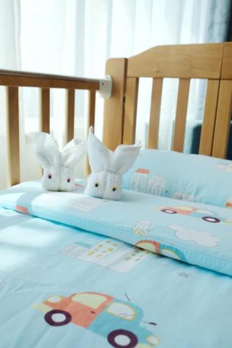 two stuffed rabbits are sitting on a bed at Holiday Inn Express Macau City Centre by IHG in Macau