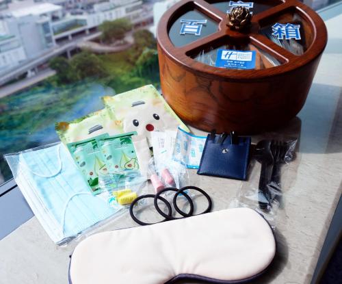 a table topped with a clock and a pair of scissors at Holiday Inn Express Macau City Centre by IHG in Macau