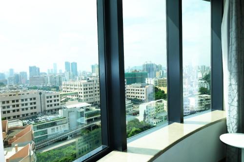 a view of a city from an office window at Holiday Inn Express Macau City Centre by IHG in Macau