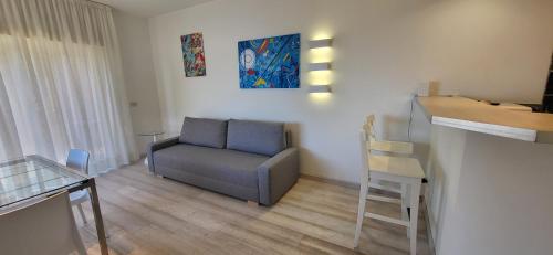 a living room with a chair and a table at COCO Apartments Taormina in Taormina