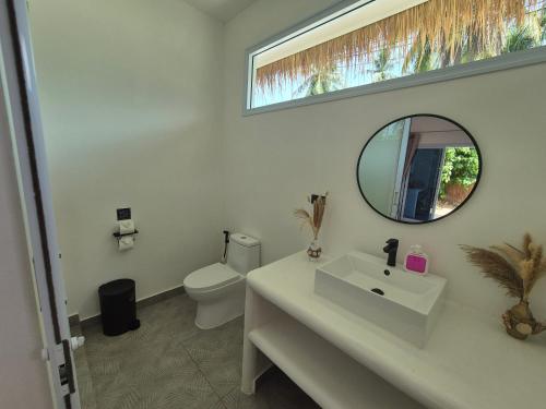 a bathroom with a white sink and a mirror at Sea Love Beach Bar & Bungalows in Ban Tai