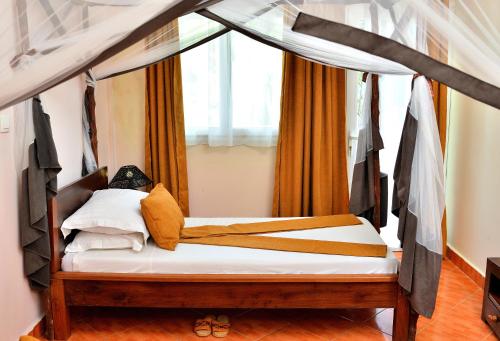 a bedroom with a bed with a canopy at Hôtel de rêve Nosy Komba in Nosy Komba