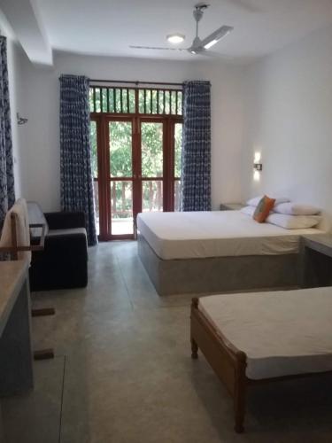 Postel nebo postele na pokoji v ubytování New Villa Unawatuna