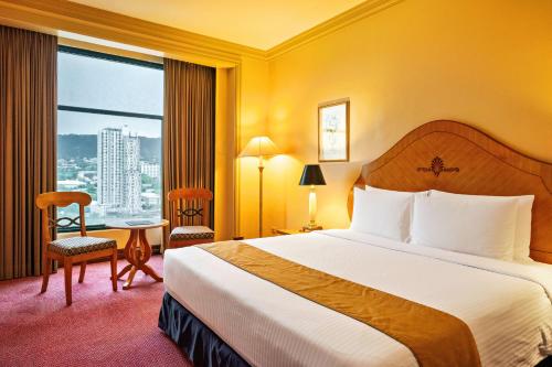 a hotel room with a bed and a large window at Waterfront Cebu City Hotel & Casino in Cebu City