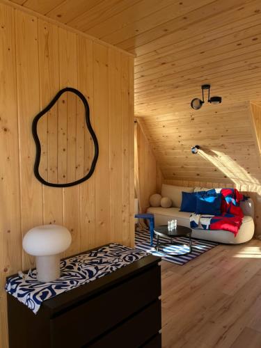 a room with a couch in a wooden cabin at Apartamenty & Pokoje MyWy in Zakopane