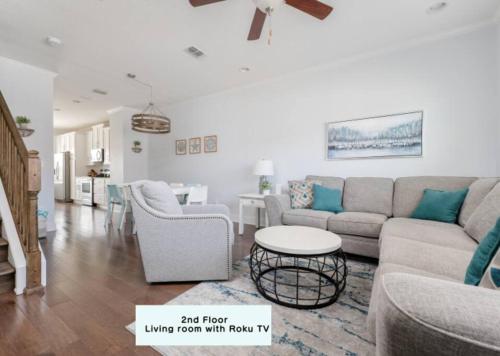 a living room with a couch and dining room with a table at Be A Nomad - Coastal Retreat 100 yds to Beach in Jacksonville Beach