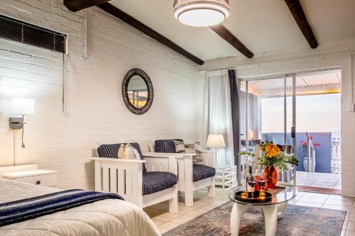 a bedroom with a bed and a table at Sea Villa Vista in St. Helena Bay