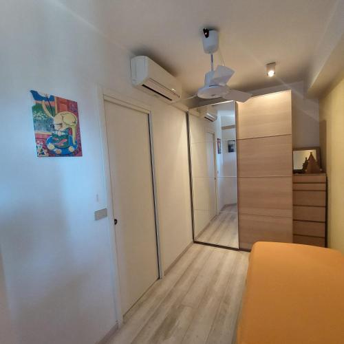a room with a hallway with a closet and a door at COCO Apartments Taormina in Taormina