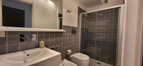 a bathroom with a sink and a toilet and a mirror at COCO Apartments Taormina in Taormina