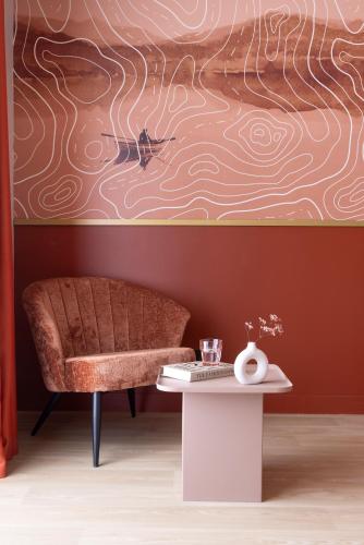 a living room with a couch and a table at Hôtel Best of Both - Divonne-les-Bains in Divonne-les-Bains