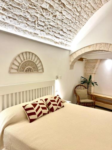a bedroom with a bed and a stone ceiling at Frida, suite in stile pugliese in Noci