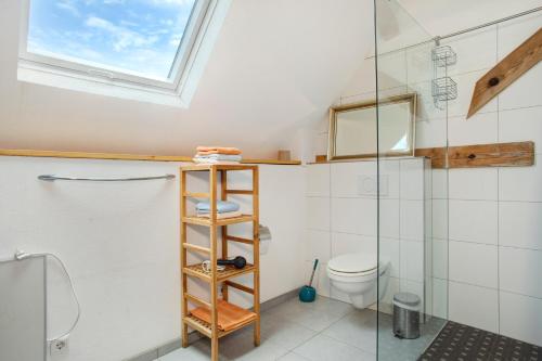 a bathroom with a toilet and a glass shower at Hof Sinnenberg in Deggenhausertal