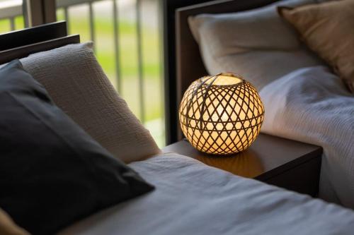 a lamp sitting on a table next to two beds at mion in Hota