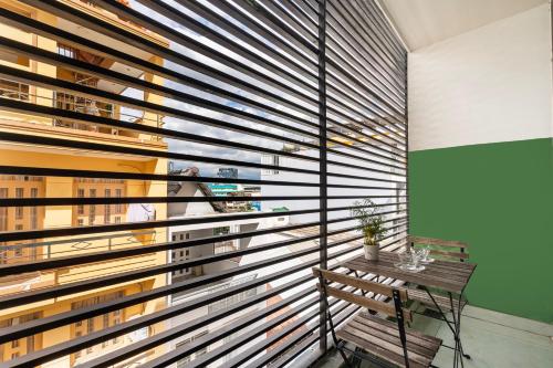 a room with a bench and a wooden wall at Gemini Saigon CENTER - New & Quiet near Bui Vien Walking Street in Ho Chi Minh City