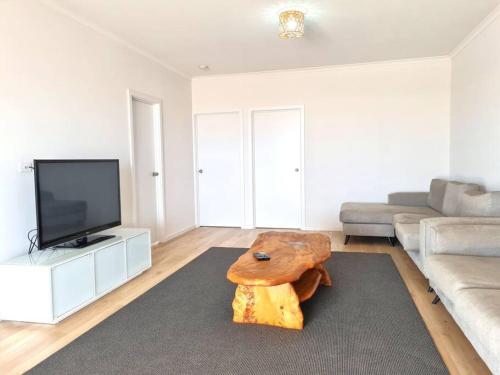 a living room with a couch and a coffee table at Beachfront Beauty in Port Moonta