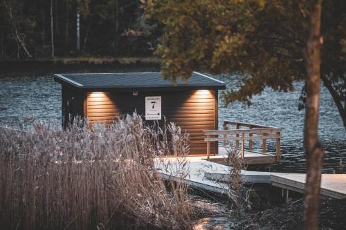 a small cabin on a dock next to the water at Marholmen in Norrtälje