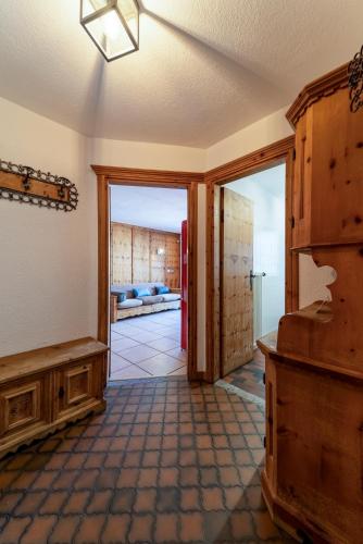 a hallway with a door leading to a living room at Chesa Silva - Silvaplana in Silvaplana