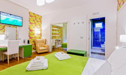 una camera con letto verde e scrivania di B&B Pellicano Guest House a Reggio di Calabria