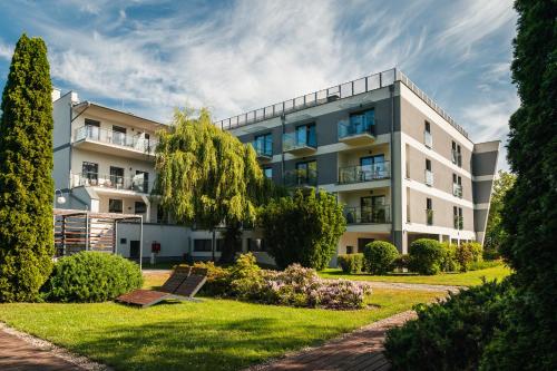 an apartment building with a lawn in front of it at Rewita Korab in Sopot