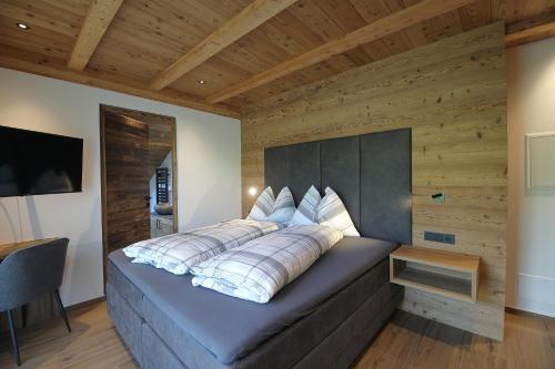 a bed with pillows on it in a room at Chalet Roderer in Laion