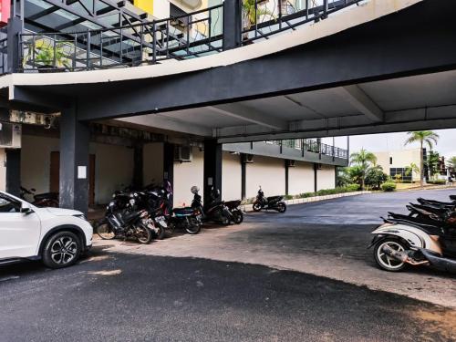 a group of motorcycles parked under a building at Baloi View Apartment in Nagoya