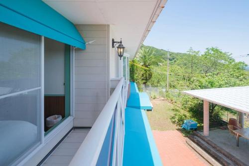 a house with a balcony with a view of a yard at Nostalgia Nasa in Nasa