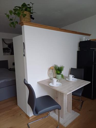 a table and a chair in a room at Wohnung 1 Tollgauer in Zennern
