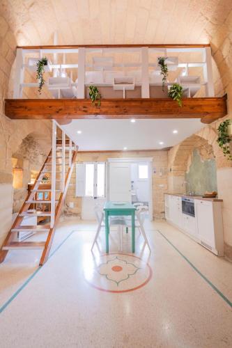 a room with a table and a bunk bed at HISTORIA- Dimore Vico Ghezzi in Carpignano Salentino