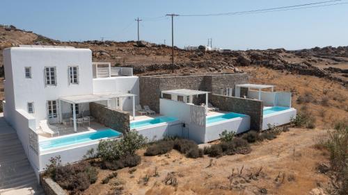 a group of white houses in the desert at The Ammonite Resort in Super Paradise Beach
