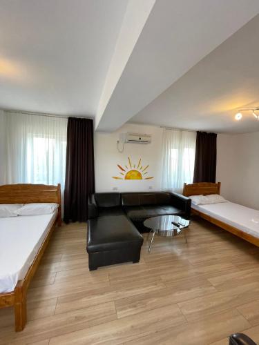 a living room with two beds and a couch at Vila Cochilia Costinesti ULTRACENTRAL 3 stele in Costinesti