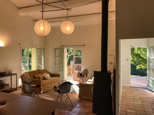 - un salon avec un canapé, des chaises et des lumières dans l'établissement La Bergerie de Chateau Fontvert, à Lourmarin