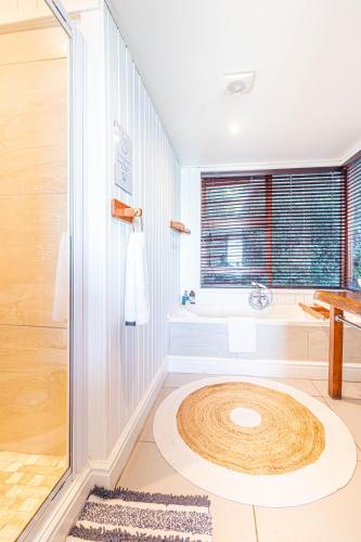 a bathroom with a large wooden circle in the middle of a shower at Peak's Cabin - Endless Ocean Views - Fireplace - Fast WiFi in Wilderness