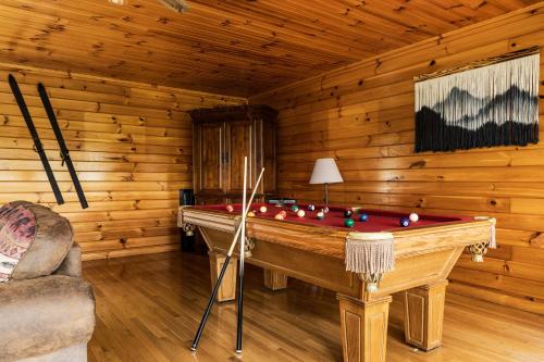 a room with a pool table in a log cabin at Elevista - Quaint&Private-Views-HotTub-PoolTable-Bears-3 Clubhouse Pools in Gatlinburg