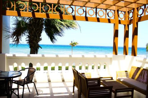 a patio with a view of the beach at Wateera Jebel Sifah in As Sīfah