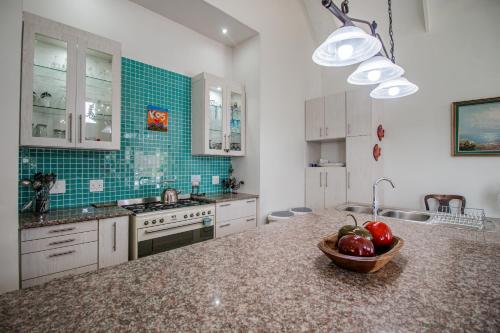 a kitchen with a bowl of fruit on a counter at Beachcomber in Paternoster