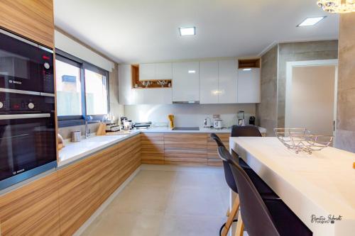 a kitchen with a table and chairs and a counter top at BS Luxury Estate El Campello in El Campello